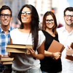portrait of young students holding books at street portrait of young students holding books at street